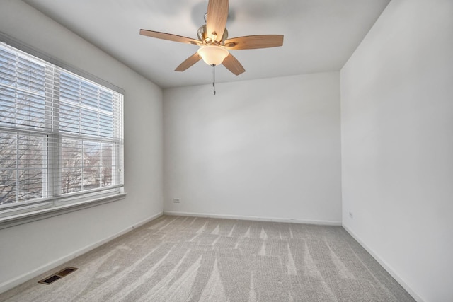 unfurnished room featuring light carpet and ceiling fan