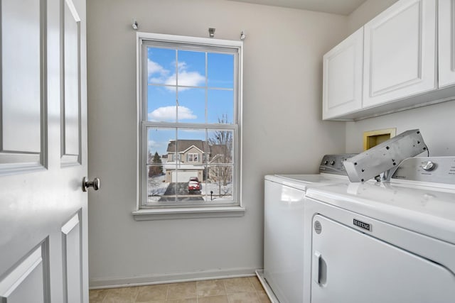 laundry area with independent washer and dryer and cabinets