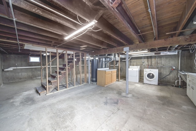 basement featuring independent washer and dryer and gas water heater