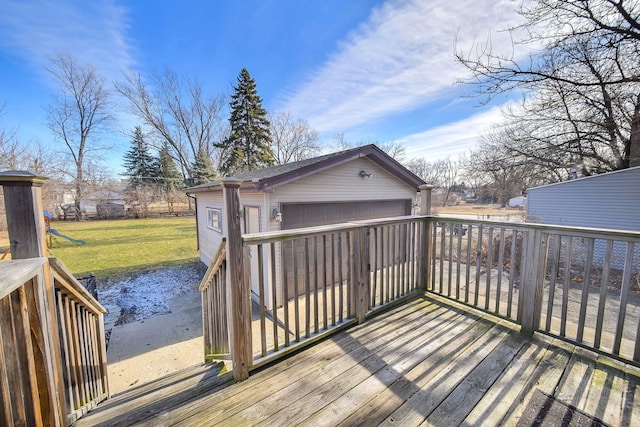 wooden terrace with an outbuilding, a garage, and a yard