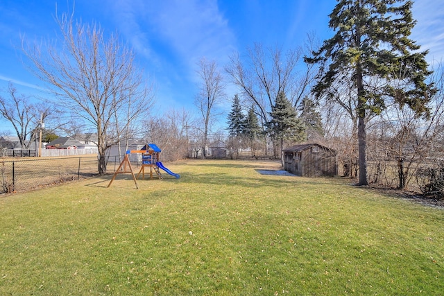 view of yard featuring a playground and a storage shed