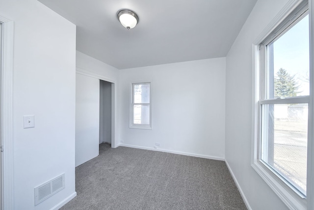 unfurnished bedroom featuring carpet flooring and a closet