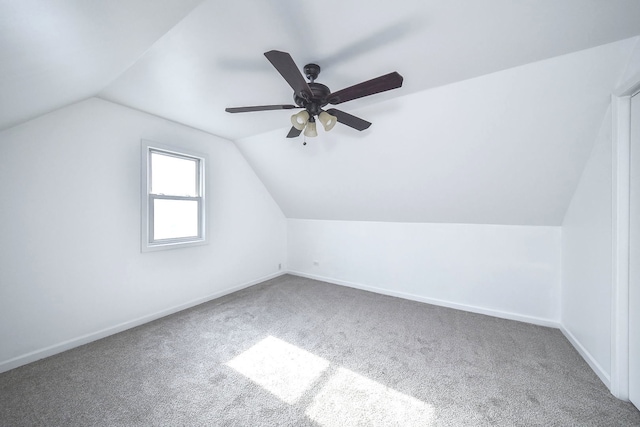 additional living space with lofted ceiling, ceiling fan, and carpet flooring