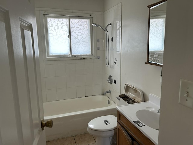 full bathroom featuring tiled shower / bath combo, vanity, tile patterned floors, and toilet