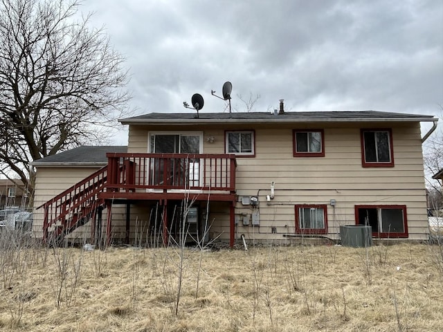 back of property featuring central AC and a deck