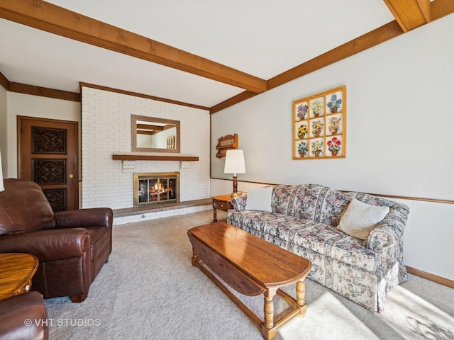 carpeted living room featuring a brick fireplace and beam ceiling