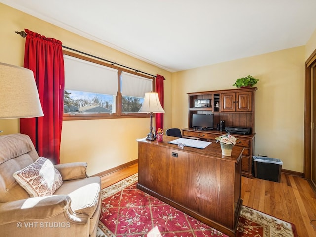 office area featuring light wood-style flooring and baseboards