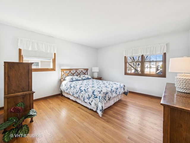 bedroom with wood finished floors and baseboards