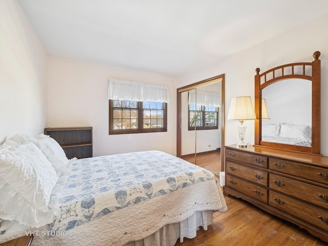 bedroom featuring light wood-style floors and a closet