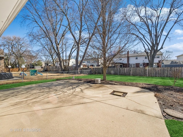 view of patio featuring playground community, fence, and a residential view