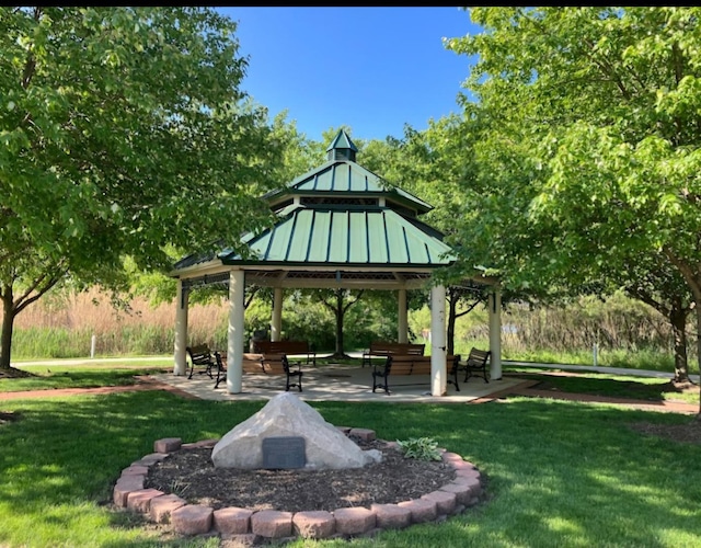 view of property's community featuring a lawn, a patio, and a gazebo