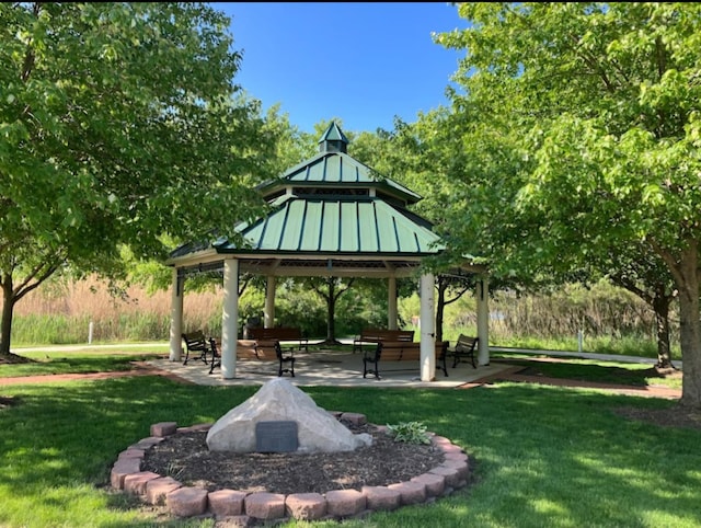 view of community with a yard, a gazebo, and a patio area