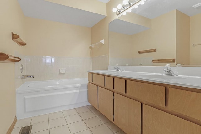 bathroom featuring tile patterned floors, vanity, and a bath