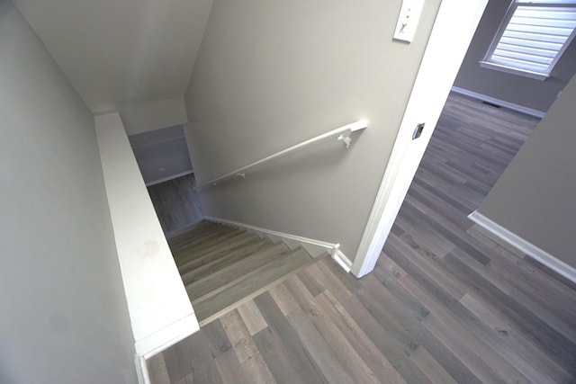 stairs with baseboards and wood finished floors