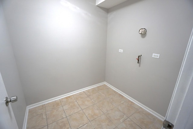 laundry room with baseboards and light tile patterned flooring