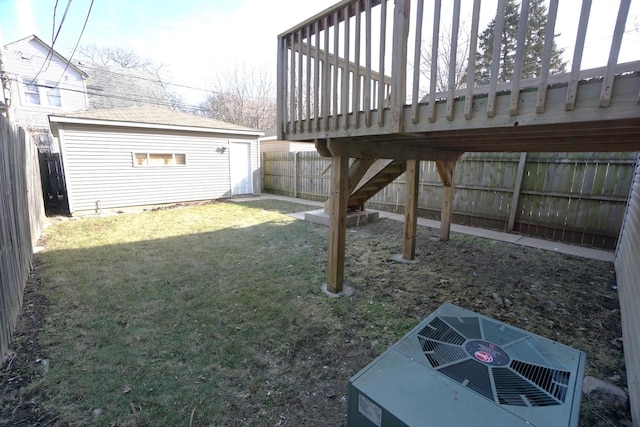 view of yard with an outbuilding, central AC unit, and a fenced backyard