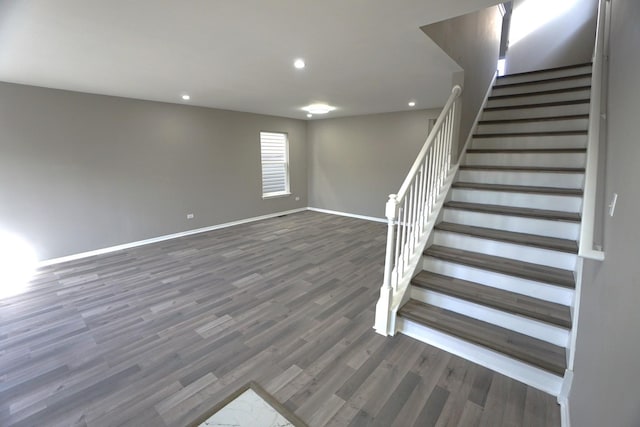 staircase featuring recessed lighting, baseboards, and wood finished floors