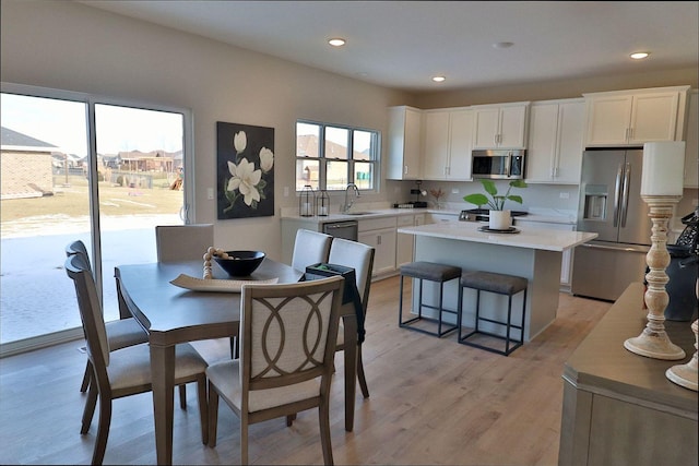 dining area with recessed lighting and light wood finished floors