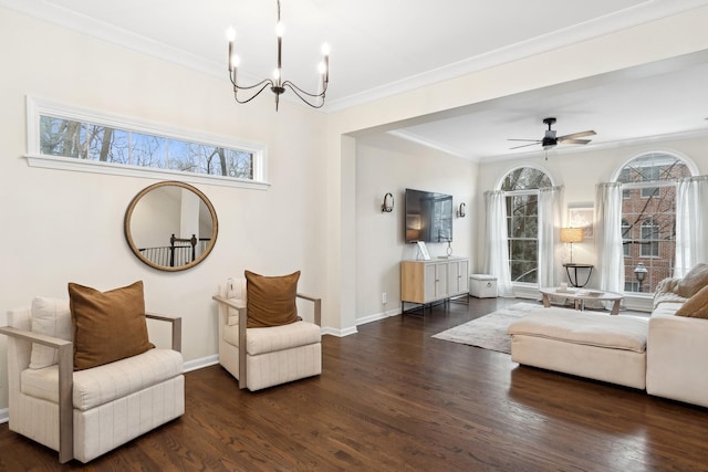 living area featuring dark hardwood / wood-style flooring, a wealth of natural light, and ornamental molding