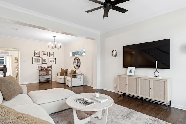 living room featuring ceiling fan with notable chandelier, dark wood-type flooring, and ornamental molding