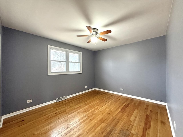 unfurnished room with wood-type flooring and ceiling fan