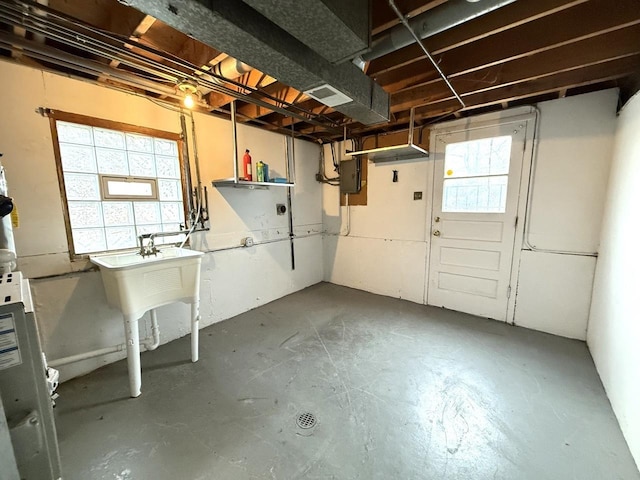 basement featuring a healthy amount of sunlight and electric panel