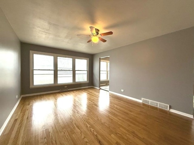 empty room with hardwood / wood-style flooring and ceiling fan