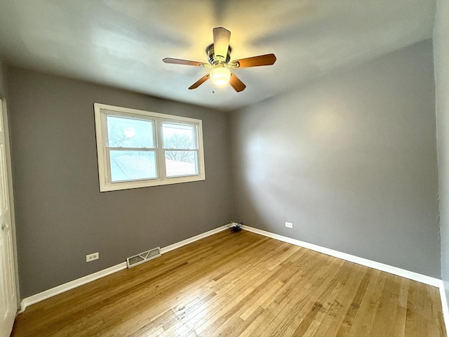 spare room featuring wood-type flooring and ceiling fan