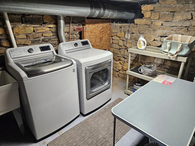 clothes washing area featuring washer and dryer