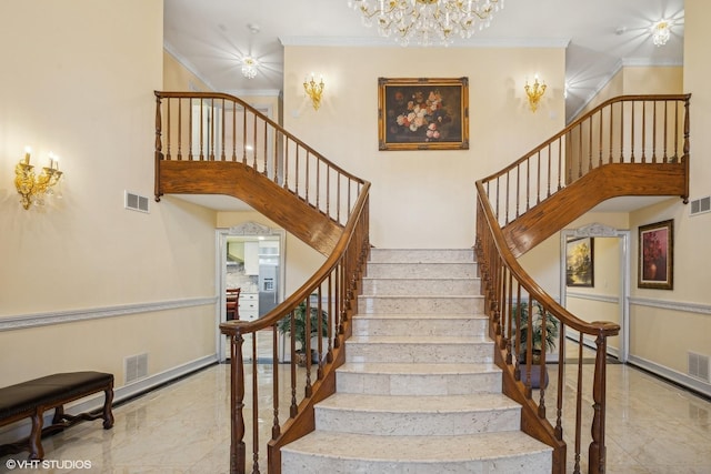 stairs featuring ornamental molding and a high ceiling