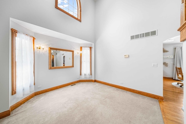 549 Beachview Dr, Lake Holiday, IL 60552 - unfurnished room with a high ceiling, visible vents, and baseboards