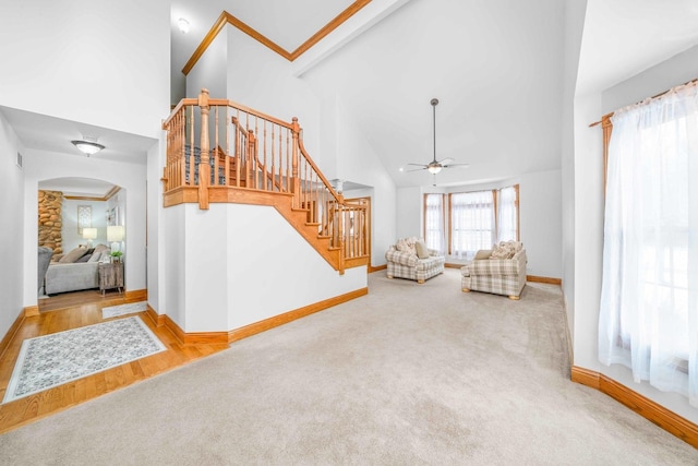 549 Beachview Dr, Lake Holiday, IL 60552 - unfurnished living room with carpet floors, arched walkways, high vaulted ceiling, and stairway