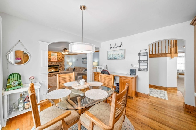 549 Beachview Dr, Lake Holiday, IL 60552 - dining area featuring baseboards, ceiling fan, a fireplace, and light wood finished floors