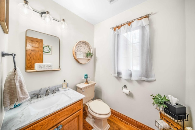 549 Beachview Dr, Lake Holiday, IL 60552 - half bath with vanity, baseboards, toilet, and wood finished floors