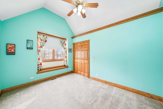 549 Beachview Dr, Lake Holiday, IL 60552 - empty room featuring visible vents, carpet floors, lofted ceiling, baseboards, and ceiling fan
