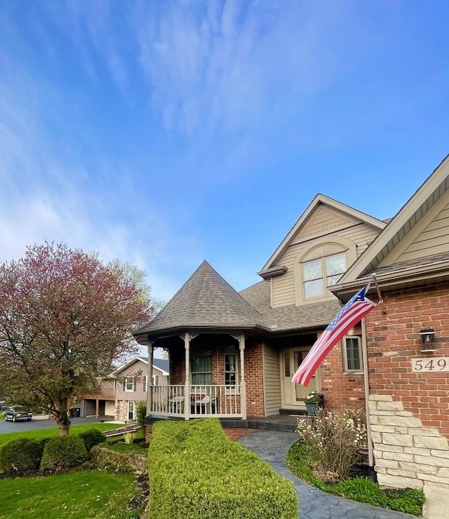 549 Beachview Dr, Lake Holiday, IL 60552 - view of front of house with a porch, brick siding, and roof with shingles