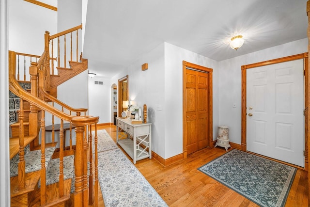 549 Beachview Dr, Lake Holiday, IL 60552 - entryway featuring visible vents, arched walkways, light wood-type flooring, stairway, and baseboards