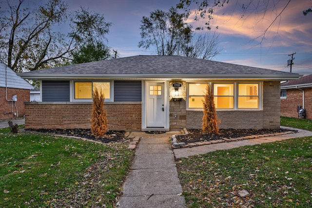 view of front of house with a yard