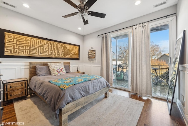 bedroom featuring access to outside, dark hardwood / wood-style floors, and ceiling fan