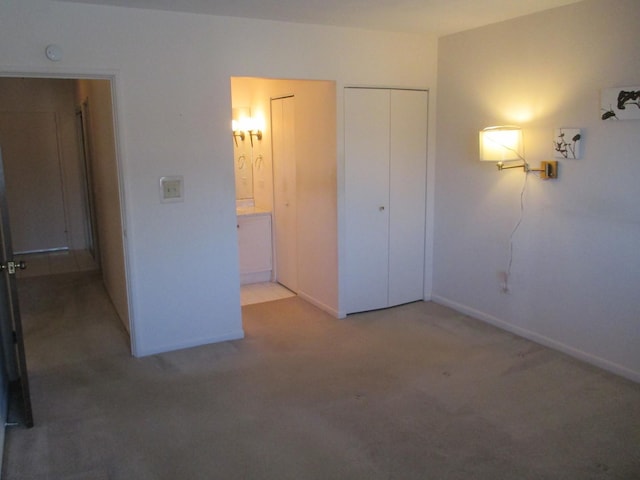 unfurnished bedroom featuring baseboards and carpet