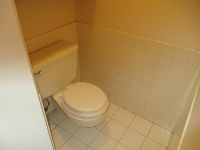 bathroom with tile walls, toilet, and tile patterned floors