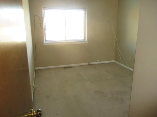 carpeted empty room with baseboards