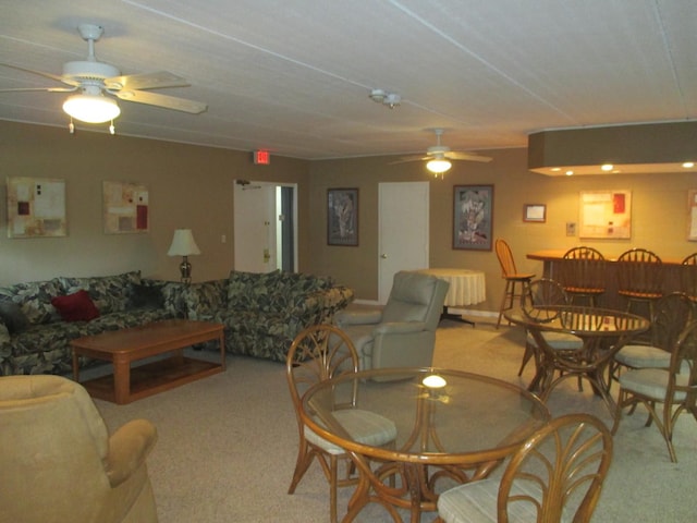 living area featuring a dry bar, ceiling fan, and light carpet