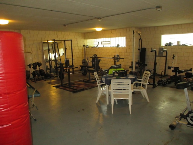 exercise room featuring concrete block wall