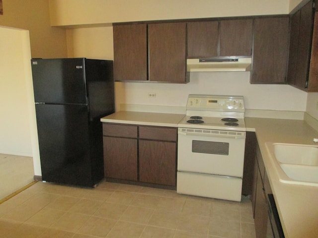 kitchen with a sink, freestanding refrigerator, under cabinet range hood, light countertops, and white electric stove