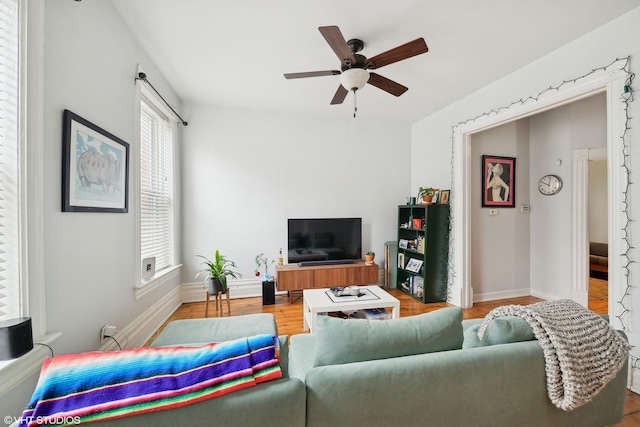 living room with hardwood / wood-style flooring and ceiling fan