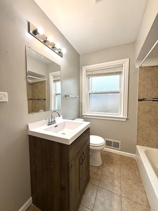 bathroom with tile patterned flooring, vanity, and toilet