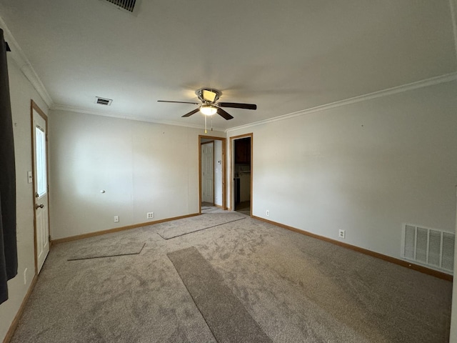 carpeted spare room with ornamental molding and ceiling fan