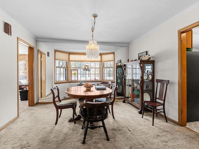 dining room featuring crown molding, carpet, and a notable chandelier