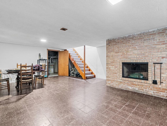 interior space featuring a fireplace and a textured ceiling